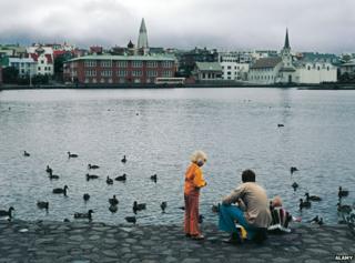 Archive picture of family gathering at Lake Tjornin in Reykjavik, feeding ducks