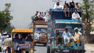 Pakistani civilians, fleeing from a military operation in North Waziristan tribal agency, arrive in Bannu district on June 18, 2014