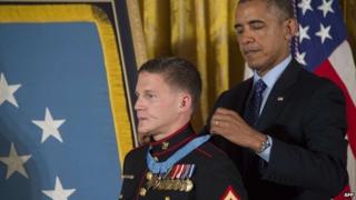 US President Barack Obama awards the Medal of Honor to US Marine Cpl William "Kyle" Carpenter during a ceremony at the White House in Washington, DC 19 June 2014