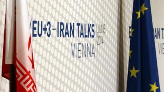 Iranian and EU flags stand in front of a poster of Iran talks in Vienna, Austria. 20 June 2014