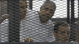 Peter Greste, Mohamed Fahmy and Baher Mohamed (L-R) listen to the ruling in court in Cairo