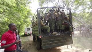A truck loaded with Kenyan security officers patrols in Mpeketoni town on 18 June 2014