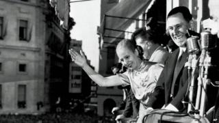 Argentine President Juan Peron, and his wife Eva, wave from the balcony of Casa Rosada in Buenos Aires on 17 October 1950 as his supporters celebrated Loyalty Day