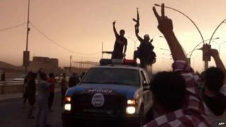 An image grab taken from a video uploaded on Youtube on June 12, 2014, allegedly shows Islamic State of Iraq and the Levant (ISIS) militants taking part in a military parade in the northern city of Mosul