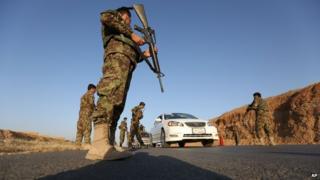 Afghan national army soldiers search a car at a checkpoint on the outskirts of Jalalabad, east of Kabul
