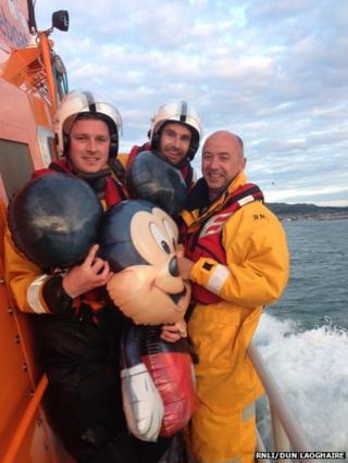 Dun Laoghaire RNLI crew with Mickey Mouse balloon they rescued from the Irish Sea