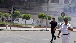 Egyptian security forces inspect the scene after two bombs went off near the presidential palace in Cairo, Egypt