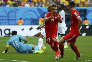 Switzerland's midfielder Xherdan Shaqiri and forward Josip Drmic (C) celebrate their victory during the Group E football match between Honduras and Switzerland at the Amazonia Arena in Manaus on 25 June 2014