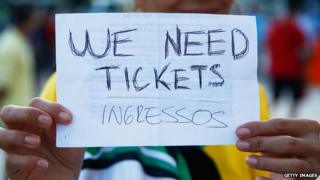 A fan holds a "We Need Tickets" sign prior to the 2014 FIFA World Cup Brazil Group F match between Argentina and Bosnia-Herzegovina at Maracana on 15 June, 2014