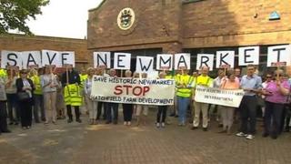 Protestors gather before a meeting to decide whether homes should be built in Newmarket