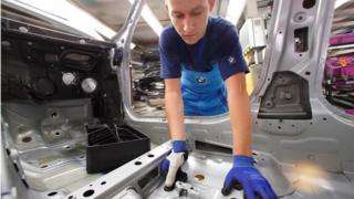 Factory worker wearing plastic thumb