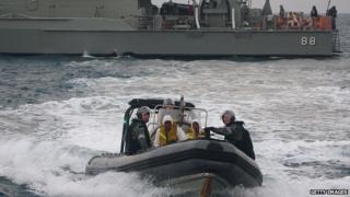 Australian navy personnel transfer asylum-seekers to Indonesian rescue boat near Panaitan island, West Java (31 August 2012)