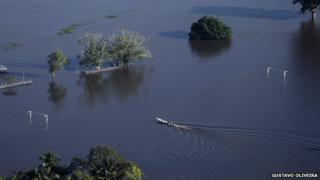 A boat crosses a submerged football pitch