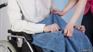 Carer and person in wheelchair