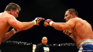 An undated photo of Dave Legeno (right) fighting in a mixed martial arts competition