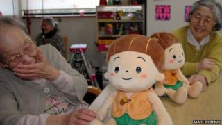 Women at a day centre interact with Kabochan toys