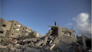 Palestinian at a destroyed building following an Israeli military strike on Beit Lahya on 15 July.