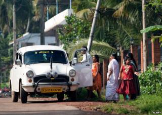 Family getting into an Ambassador car