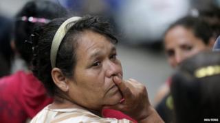 Relatives and friends wait for news of their children outside the home in the western city of Zamora on 16 July, 2014