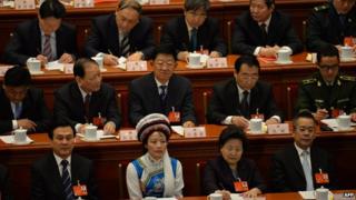 Delegates take part in the closing session of the National People's Congress (NPC) at the Great Hall of the People in Beijing on 13 March 2014.