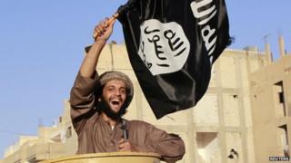 Isis fighters hold a military parade in the Syrian city of Raqqa (30 June 2014)