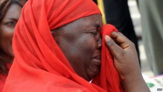 One of the mothers of the missing Chibok school girls wipes her tears as she cries during a rally by civil society groups pressing for the release of the girls in Abuja on 6 May 2014