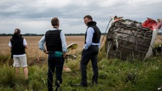 Alexander Hug, centre, deputy head of the OSCE mission, stands at the crash site