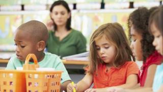 Children play in a preschool classroom.