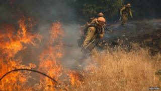 Fire fighters battle a spot fire near Plymouth, California (26 July 2014)