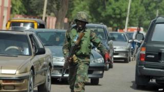 An officer pictured amidst the traffic of Maiduguri, Nigeria - April 2013