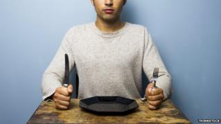 A man waiting to eat on his own