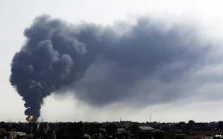 Smoke billows from a fuel storage depot near the airport in Tripoli, Libya, 28 July