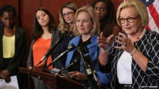 Sen. Claire McCaskill (D-MO) (R) and Sen. Kristen Gillibrand (D-NY) are joined by survivors of campus sexual assault during a news conference at the US Capitol Visitors Center 30 July 2014