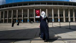 A Turkish citizen enters the Olympic Stadium in Berlin to cast her vote in presidential elections in Turkey (31 July 2014)