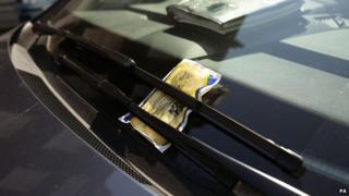 A parking ticket on a car