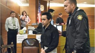 Suspect Chad DeSoto (centre) is escorted from a Superior Court of Guam courtroom during a midday break on Monday, 23 June, 2014, in Hagatna, Guam