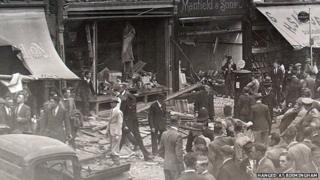 The scene after the explosion with crowds gathering