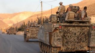 Lebanese army"s armoured personal carriers (APC) enter the town of Arsal in the Bekaa valley by the Syrian border on 2 August 2014