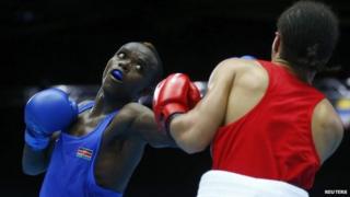 Benson Gicharu Njangiru (L) of Kenya and Tafari Ebanks of the Cayman Islands box during their men's bantamweight quarter-final bout at the 2014 Commonwealth Games in Glasgow, Scotland, 30 July 2014