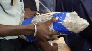 Screen grab taken on 27 July 2014 o a Malian police officer holding one of the two black boxes of the Air Algerie AH5017 retrieved at the crash site in Mali's Gossi region