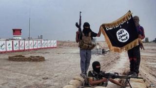 Militants of the Islamic State posing with the trademark Jihadists flag after they allegedly seized an Iraqi army checkpoint in the northern Iraqi province of Salahuddin