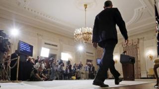 President Barack Obama approaches the podium to speak about the situation in Iraq in the State Dining Room at the White House in Washington, Thursday, Aug. 7