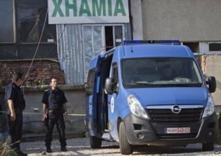 Police outside makeshift mosque in Kosovo (11 August)