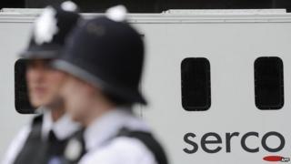 police standing in front of a Serco van
