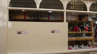 Boarded up window of Guernsey jeweller Martin and Martin after smash and grab burglary