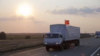 A convoy of white trucks carrying humanitarian aid passes along the main road M4 (Don highway) Voronezh region, Russia,
