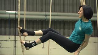 woman climbing ropes