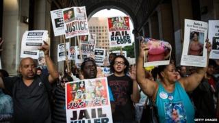 Protesters hold a rally in solidarity with the people in Ferguson, Missouri protesting the death of Michael Brown and the excessive use of force by police in New York City 18 August 2014