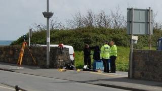 Guernsey Police officers examining crash site at Salerie Corner