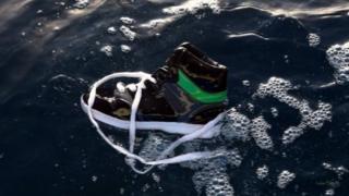 A shoe belonging to an illegal immigrant floats on the water after a boat carrying illegal migrants sank off Libya